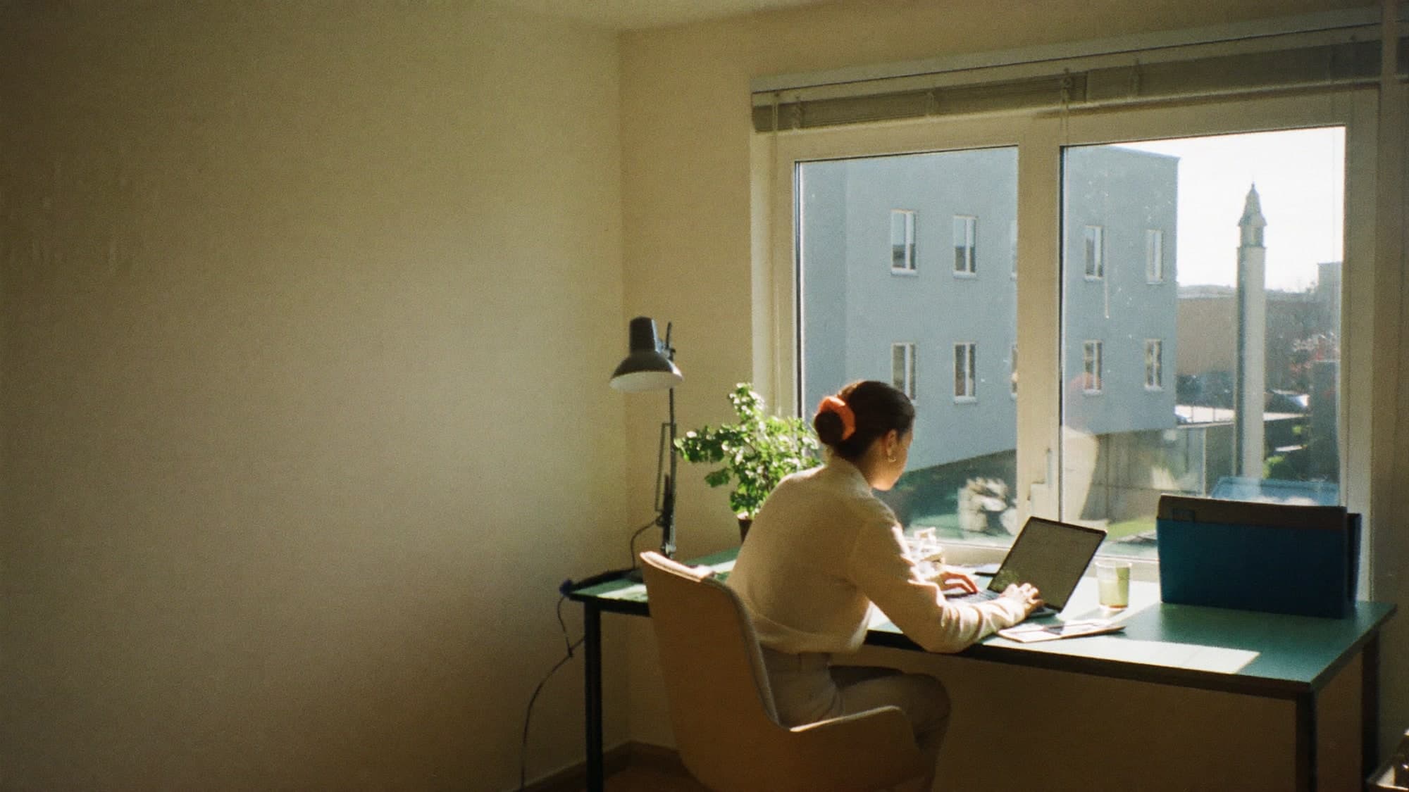 A housing professional reading at a desk in a bright office.